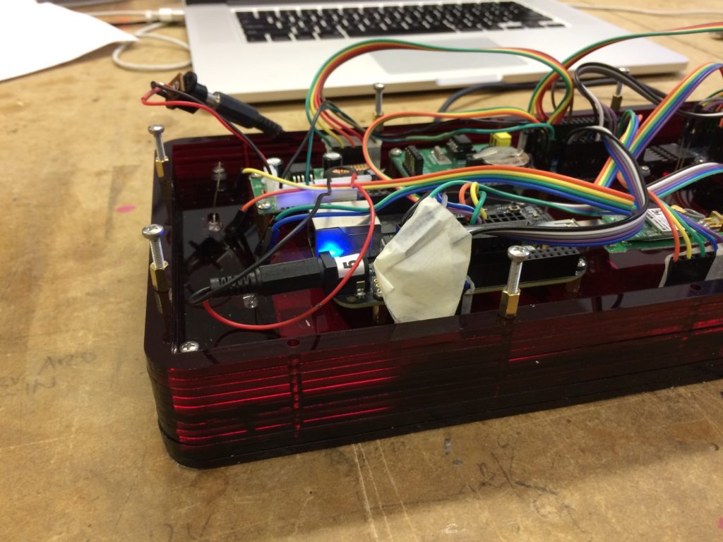side of digital clock showing laminations of the case and the inner electronics and wires