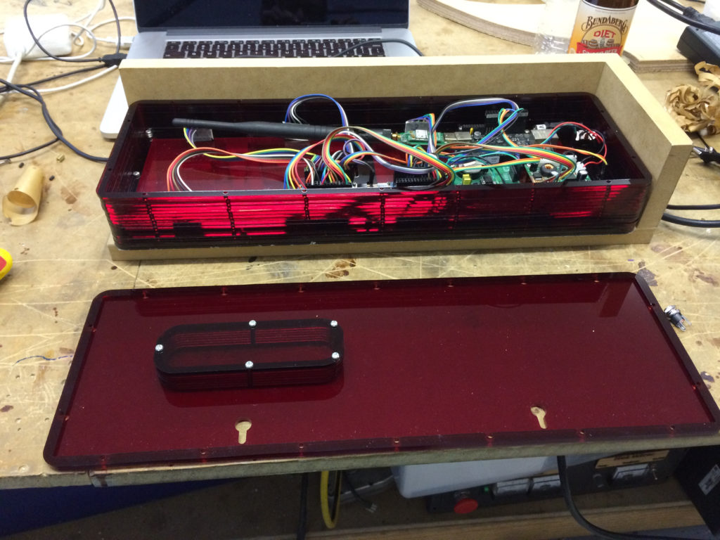 red perspex box with clock electronics showing, rear lid off