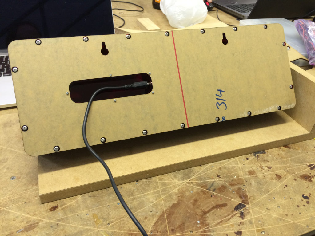 rear panel of clock with wire going into the finger slot