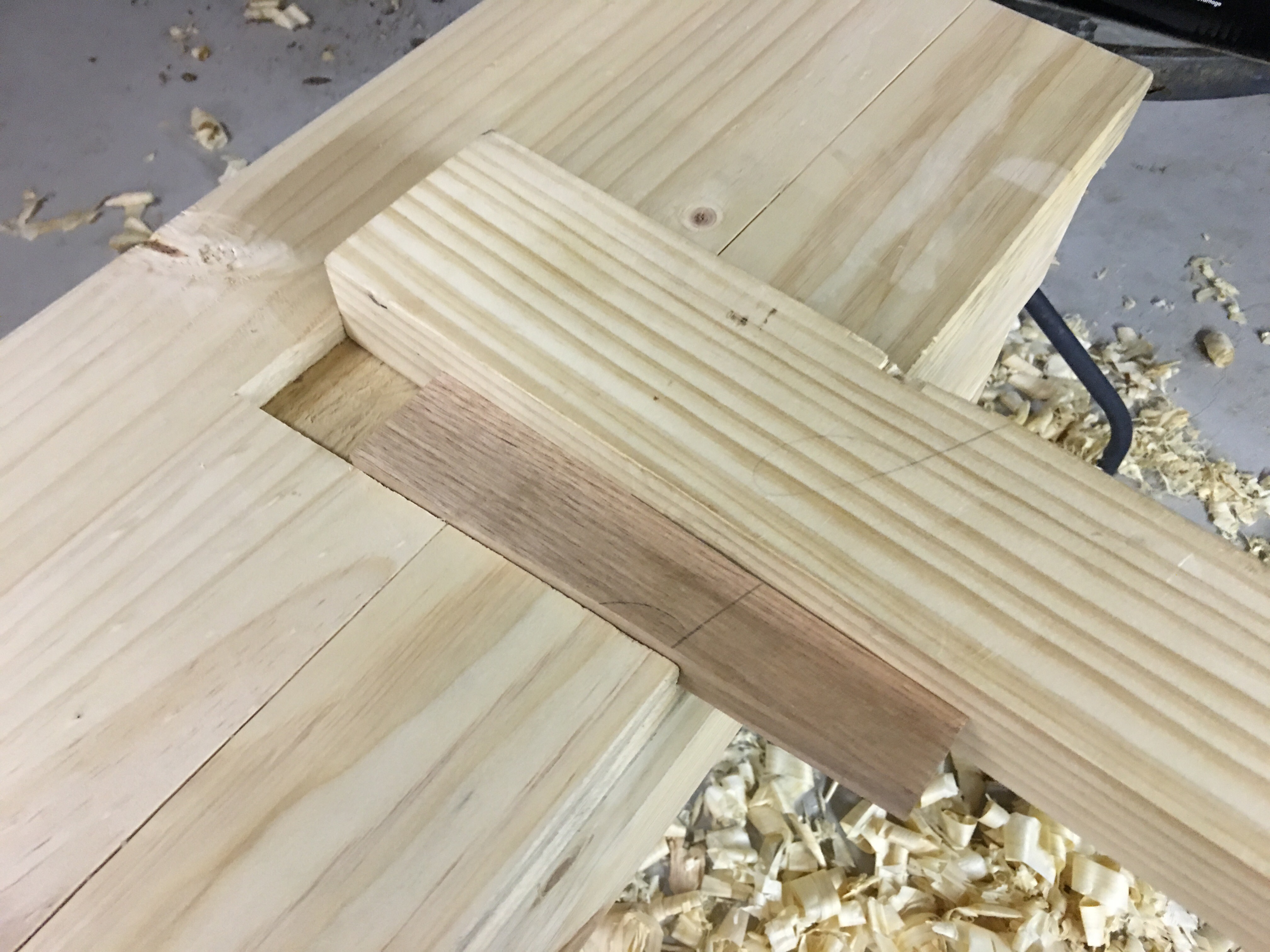 pine board with pine leg held in with wedge