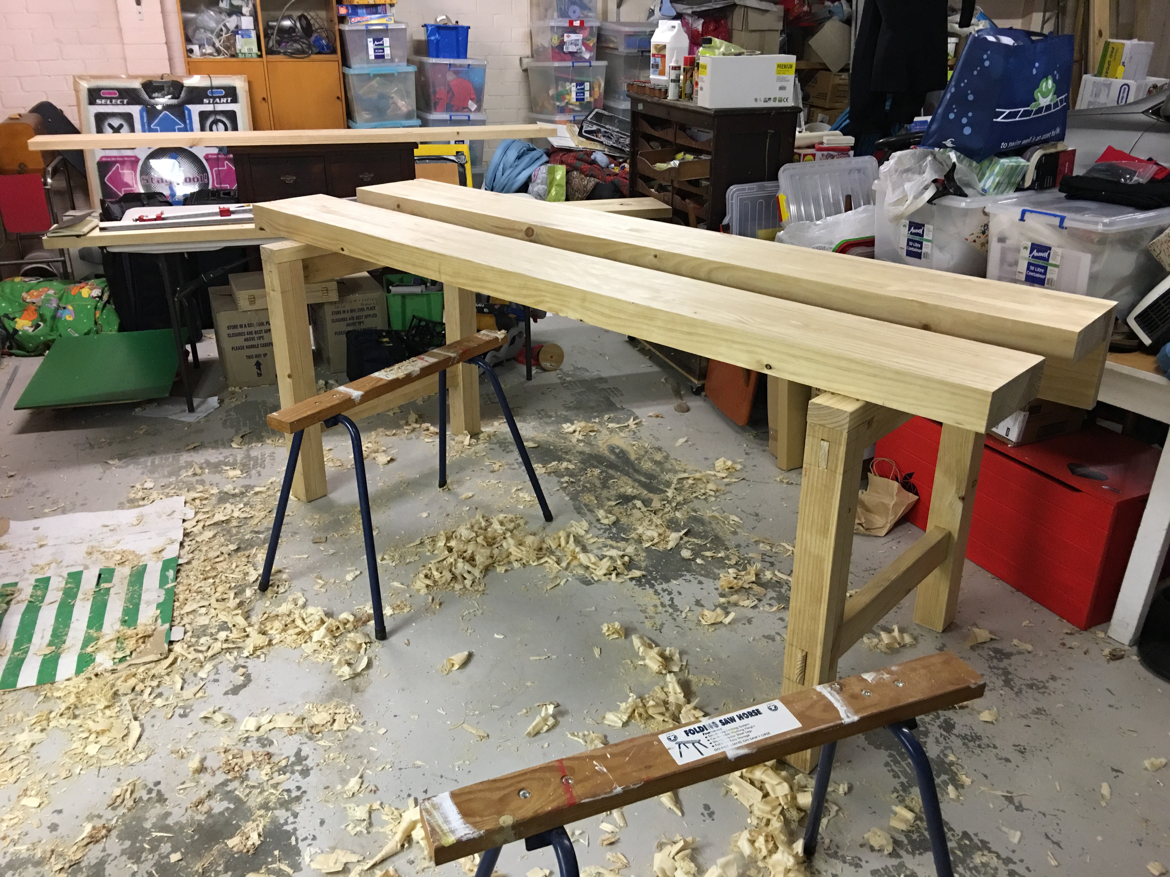 thick pine workbench tops resting on the pine leg struts